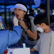 A health worker takes a nucleic acid sample for covid-19 at the arriving passengers terminal at the Zhuhai train station in Zhuhai, in southern China’s Guangdong province on September 27, 2021.